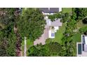 Aerial view of the home showcasing its backyard pool and landscaping, surrounded by mature trees at 211 60Th S Ave, St Petersburg, FL 33705
