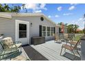 Relaxing back deck with comfortable seating, perfect for enjoying the outdoors and entertaining guests at 2221 W Lake Dr, Wimauma, FL 33598