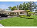 Well-maintained condo with lush lawn and covered parking, creating an inviting exterior at 2460 Northside Dr # 708, Clearwater, FL 33761
