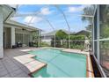 A screened-in pool provides a private outdoor oasis for relaxation and recreation at 27826 Sora Blvd, Wesley Chapel, FL 33544