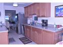 Bright kitchen featuring wood cabinets, stainless steel appliances, and a view of the dining area at 3200 Cove Cay Dr # 5F, Clearwater, FL 33760