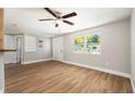 Bright living room featuring hardwood floors, fresh paint and a ceiling fan, perfect for entertaining at 3509 Brookston Dr, Holiday, FL 34691