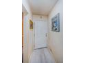 The home's interior entryway featuring a white door and plank flooring at 5265 E Bay Dr # 521, Clearwater, FL 33764