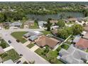 Aerial view showcasing the property's location near a lake and surrounded by lush greenery at 7022 Kingsway Dr, Port Richey, FL 34668