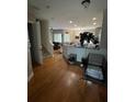 Open concept living space with hardwood floors and staircase at 8405 Costa Bella Way, Temple Terrace, FL 33637