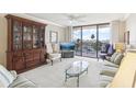 Comfortable living room featuring a sliding glass door and wood cabinet at 1 Key Capri # 302E, Treasure Island, FL 33706