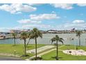 Scenic recreation area with shuffleboard, barbeque grills, palm trees, and waterfront views at 1 Key Capri # 302E, Treasure Island, FL 33706