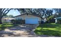 Cozy single-story home features a clean white garage door at 10502 Orange Blossom Ln, Seminole, FL 33772