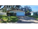Home features a well-manicured lawn and a clean white garage door at 10502 Orange Blossom Ln, Seminole, FL 33772