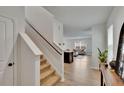 Bright foyer with hardwood floors and staircase that flows into the spacious living room at 11019 Leland Groves Dr, Riverview, FL 33579