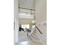 Open floorplan with a view of a staircase, entry, and living room featuring large windows at 11408 Scribner Station Ln, Lithia, FL 33547