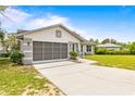 Beautifully maintained single-story home featuring a screened garage and a neatly kept front yard at 12546 Brookside St, Spring Hill, FL 34609