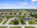 Expansive aerial view of a quiet neighborhood with lush trees and well-maintained homes at 13384 Brighton St, Spring Hill, FL 34609