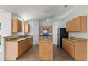 Spacious kitchen with light wood cabinets, granite countertops, stainless appliances, and tile flooring at 14006 Amero Ln, Spring Hill, FL 34609