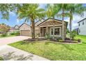 Charming home features a brick driveway, a two-car garage, and stone accents on the facade at 1830 Cameron Ct, Trinity, FL 34655