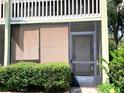 Close up of the condo doorway with screened door at 1865 Mazo Manor # 1, Lutz, FL 33558