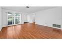 Spacious living room with hardwood floors, large windows, and ample natural light at 2559 Redwood Cir, Clearwater, FL 33763