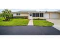 Villa with landscaped front yard, sidewalk and attached garage providing convenience and aesthetic appeal at 2814 Highlands Blvd # B, Palm Harbor, FL 34684
