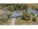 Overhead shot captures the home's layout, backyard, and proximity to the road and surrounding greenery at 3144 Abeline Rd, Spring Hill, FL 34608