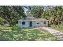 Charming single-story home featuring a well-manicured lawn and mature trees, offering great curb appeal at 3205 68Th N Ave, St Petersburg, FL 33702