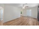 Inviting living room with wood-look floors, a ceiling fan and arched doorways at 3205 68Th N Ave, St Petersburg, FL 33702