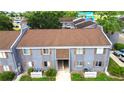 An aerial view of a two-story condominium showcasing the front facade, roof and green landscaping at 3805 Cortez Cir # B, Tampa, FL 33614
