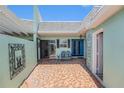 Private courtyard with seating, a blue door and terracotta pavers at 384 Boca Ciega Point Blvd, St Petersburg, FL 33708