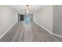 Spacious living room boasts hard wood flooring and sliding glass doors with waterfront views at 384 Boca Ciega Point Blvd, St Petersburg, FL 33708