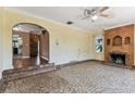 Spacious living room with unique tile flooring, a decorative fireplace, and arched entryways, enhancing its charm at 4435 1St S Ave, St Petersburg, FL 33711