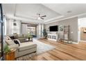 Cozy living room with wood floors, recessed lights, and a sliding glass door leading to the outdoors at 4465 Tubular Run, Land O Lakes, FL 34638
