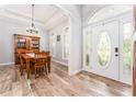 Bright foyer with decorative front door, beautiful floors, and views of dining area at 5927 Flatwoods Manor Cir, Lithia, FL 33547