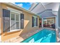 Inviting backyard pool featuring a screened-in patio area, perfect for relaxation and outdoor entertaining at 6207 Bleeker St, Riverview, FL 33578