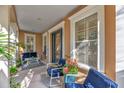 Comfortable front porch with cozy seating, creating an inviting and relaxing outdoor space at 6207 Bleeker St, Riverview, FL 33578