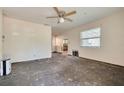Spacious living room with a ceiling fan, bright window, and easy access to the kitchen at 6730 10Th Avenue S Ter, St Petersburg, FL 33707