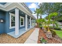 Inviting front porch featuring stately columns and charming landscaping, creating a welcoming entrance at 8332 Swiss Chard Cir, Land O Lakes, FL 34637