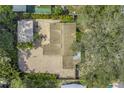 Aerial view of a home featuring a brick paved driveway and lush landscaping surrounding the property at 914 Sandpiper Way S, St Petersburg, FL 33707