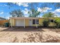 Charming single-story home featuring yellow siding, an attached garage, and brick paved driveway at 914 Sandpiper Way S, St Petersburg, FL 33707
