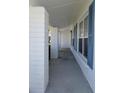 Covered porch with brick columns and blue shutters creating a welcoming entrance at 9218 40Th N Way, Pinellas Park, FL 33782