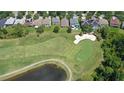 A high angle aerial of a pristine golf course neighborhood with sand traps and ponds at 10559 Coral Key Ave, Tampa, FL 33647