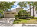 Charming single-Gathering home with mature landscaping, a two-car garage, and well-manicured lawn at 10559 Coral Key Ave, Tampa, FL 33647