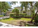 Charming single-Gathering home with mature landscaping, a two-car garage, and well-manicured lawn at 10559 Coral Key Ave, Tampa, FL 33647