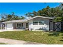 Beautiful single-story home featuring a well-kept lawn and a charming curb appeal with lush landscaping at 1144 Woodbrook Dr, Largo, FL 33770