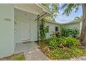 Inviting entrance featuring lush landscaping, a well-kept lawn, and a covered porch with support beam at 1309 11Th W Ave, Palmetto, FL 34221