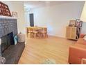 Open-concept living area with modern lighting, fireplace and dining table set at 1972 Briarwood St, Dunedin, FL 34698