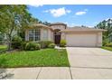 Inviting single-story home featuring a two-car garage and well-maintained landscaping on a bright day at 2544 Rosehaven Dr, Wesley Chapel, FL 33544