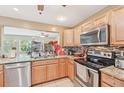 Modern kitchen featuring stainless steel appliances, granite countertops, and a stylish mosaic backsplash at 3156 Depew Ave, Port Charlotte, FL 33952