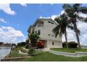 Beautiful two-story home features a balcony, lush landscaping, and waterfront access at 3402 Amberjack Dr, Hernando Beach, FL 34607