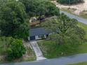 Beautiful aerial view showcasing home surrounded by large trees and greenery at 34819 Hibiscus Dr, Dade City, FL 33523