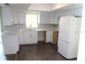 Bright kitchen with white cabinets, modern countertops, and stainless steel appliances at 38668 Ferm Cir, Zephyrhills, FL 33540