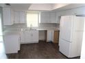 Bright kitchen with white cabinets, modern countertops, and stainless steel appliances at 38668 Ferm Cir, Zephyrhills, FL 33540